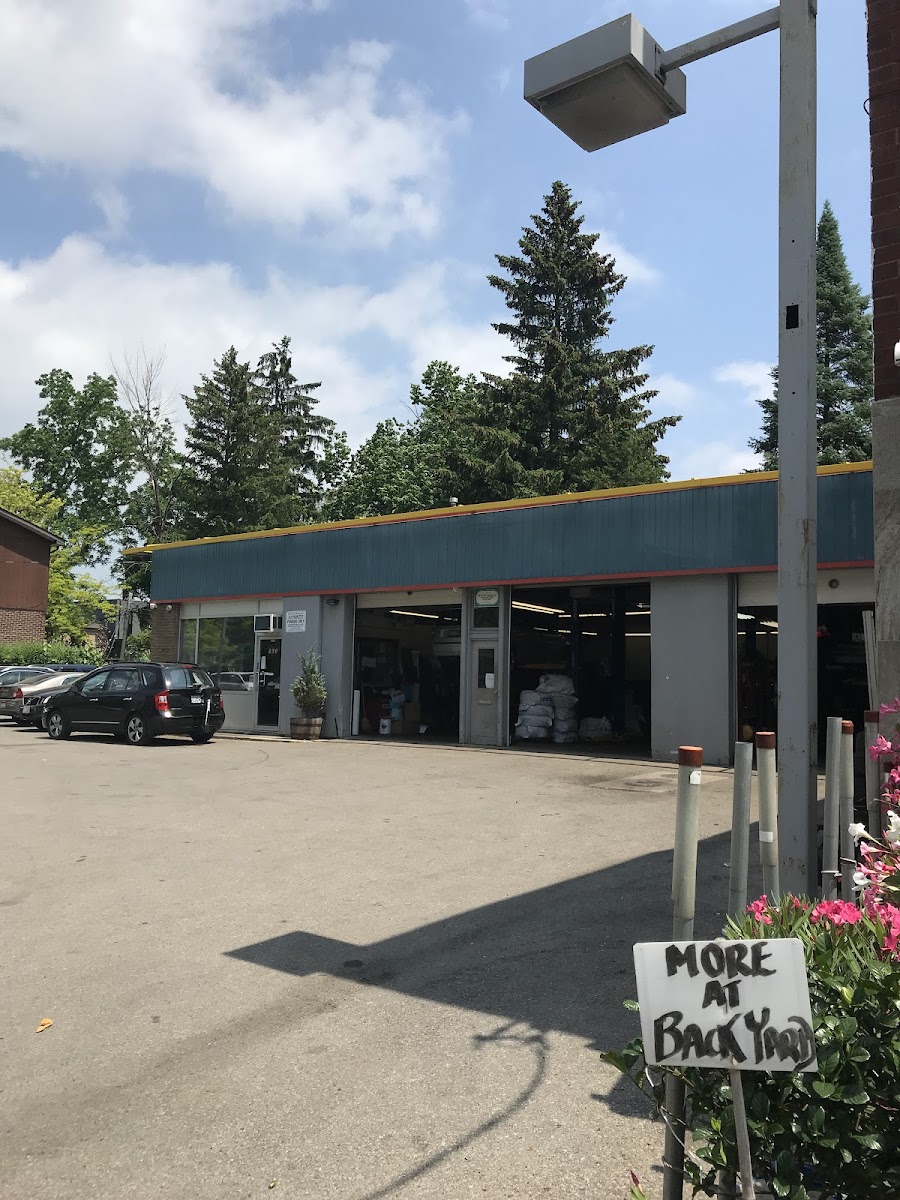 The shop frontage on a summer afternoon, garage doors open